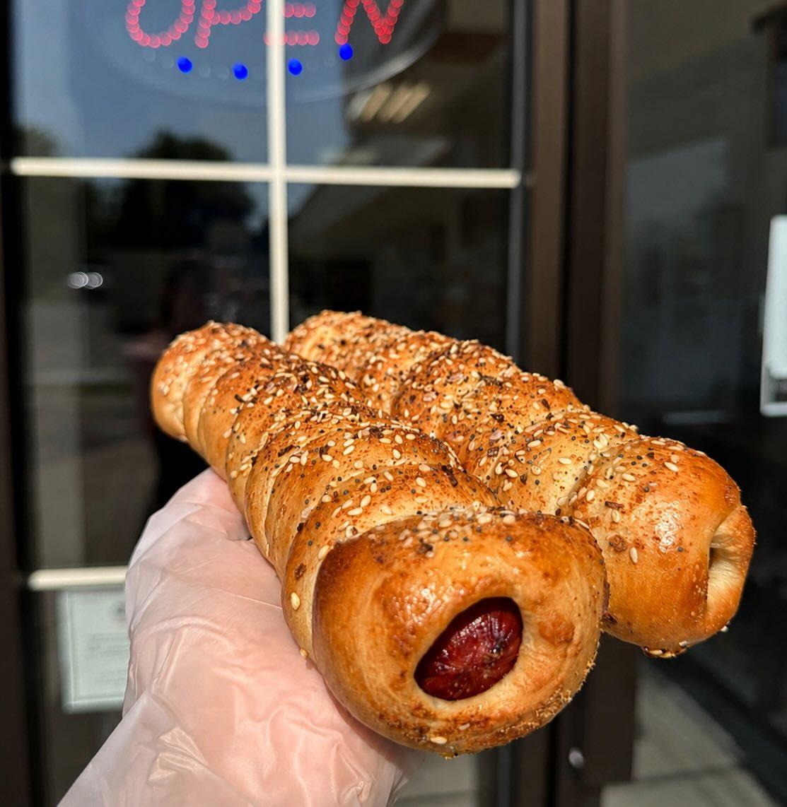Our new bagel dog! 2 beef hot dogs wrapped and baked in bagel dough Our new bagel dog! 2 beef hot dogs wrapped and baked in bagel dough