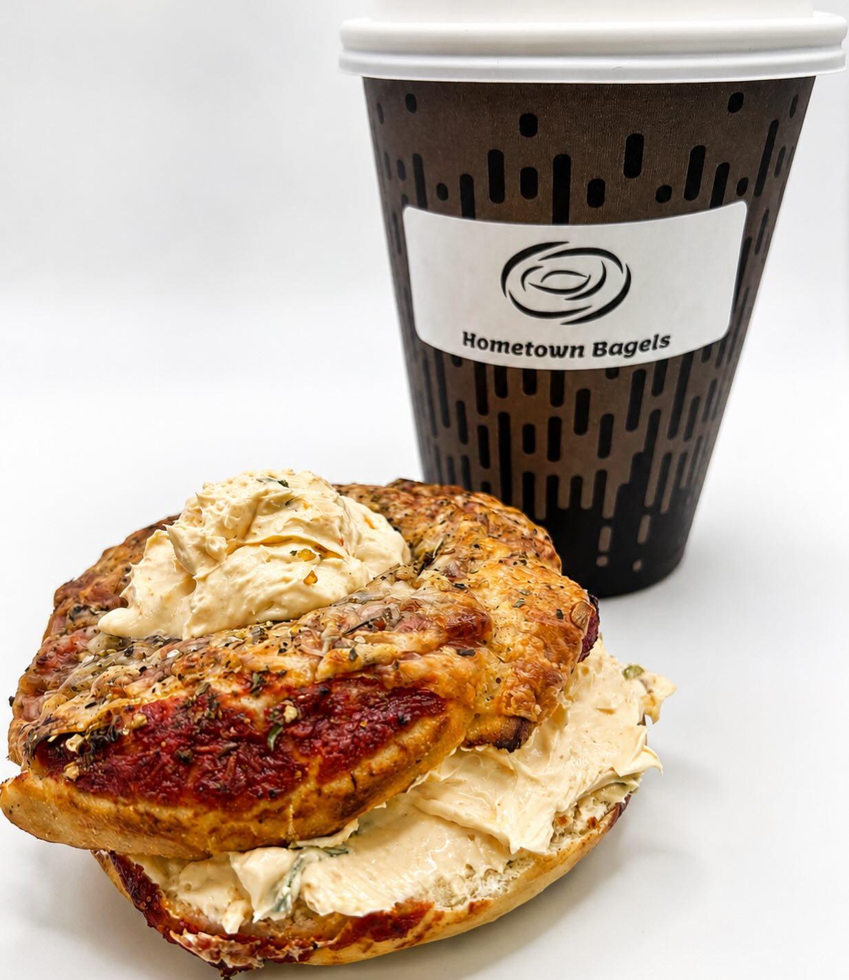 Mini pizza bagel with buffalo dip flavoured cream cheese and a coffee